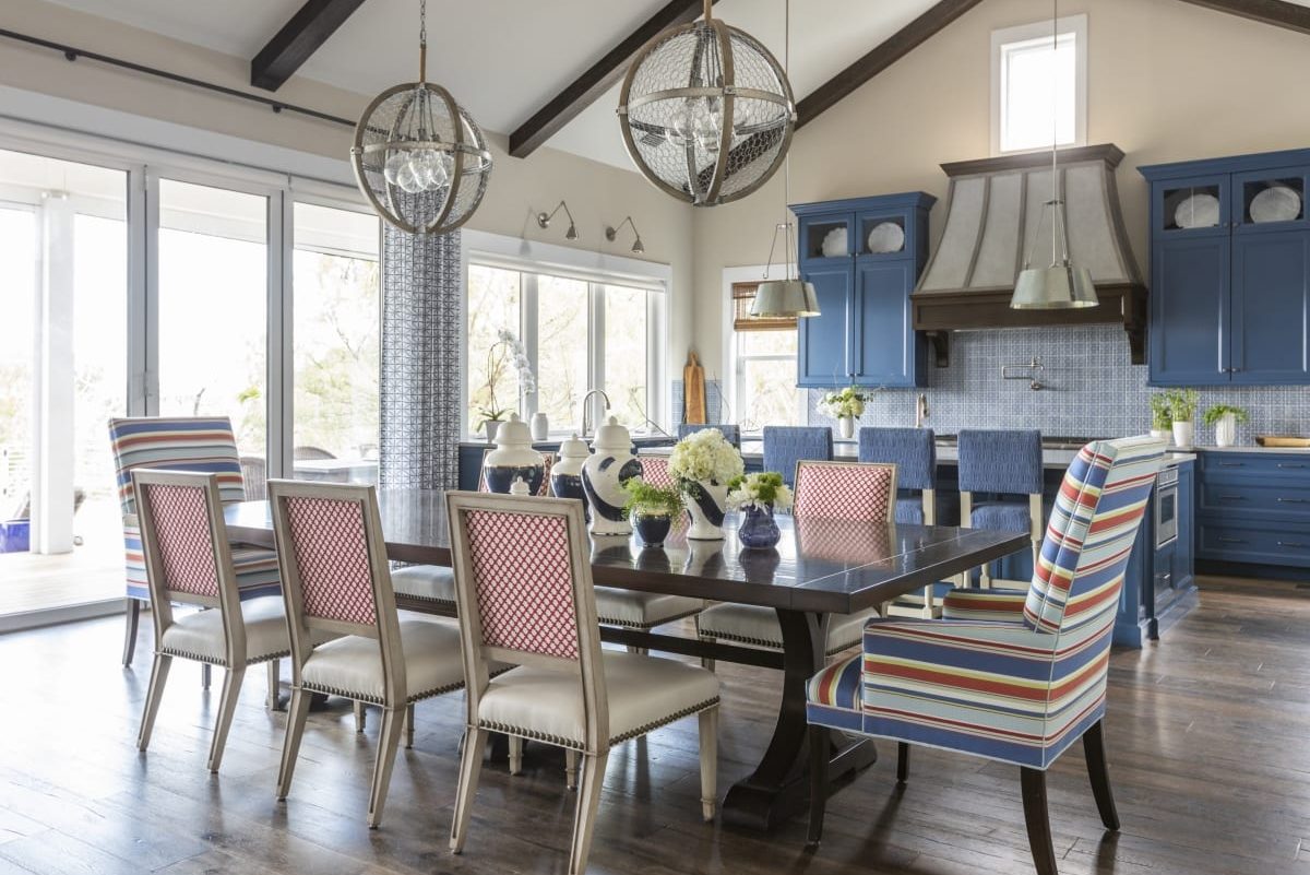 Elegant dining room with patterned chairs and modern chandeliers.