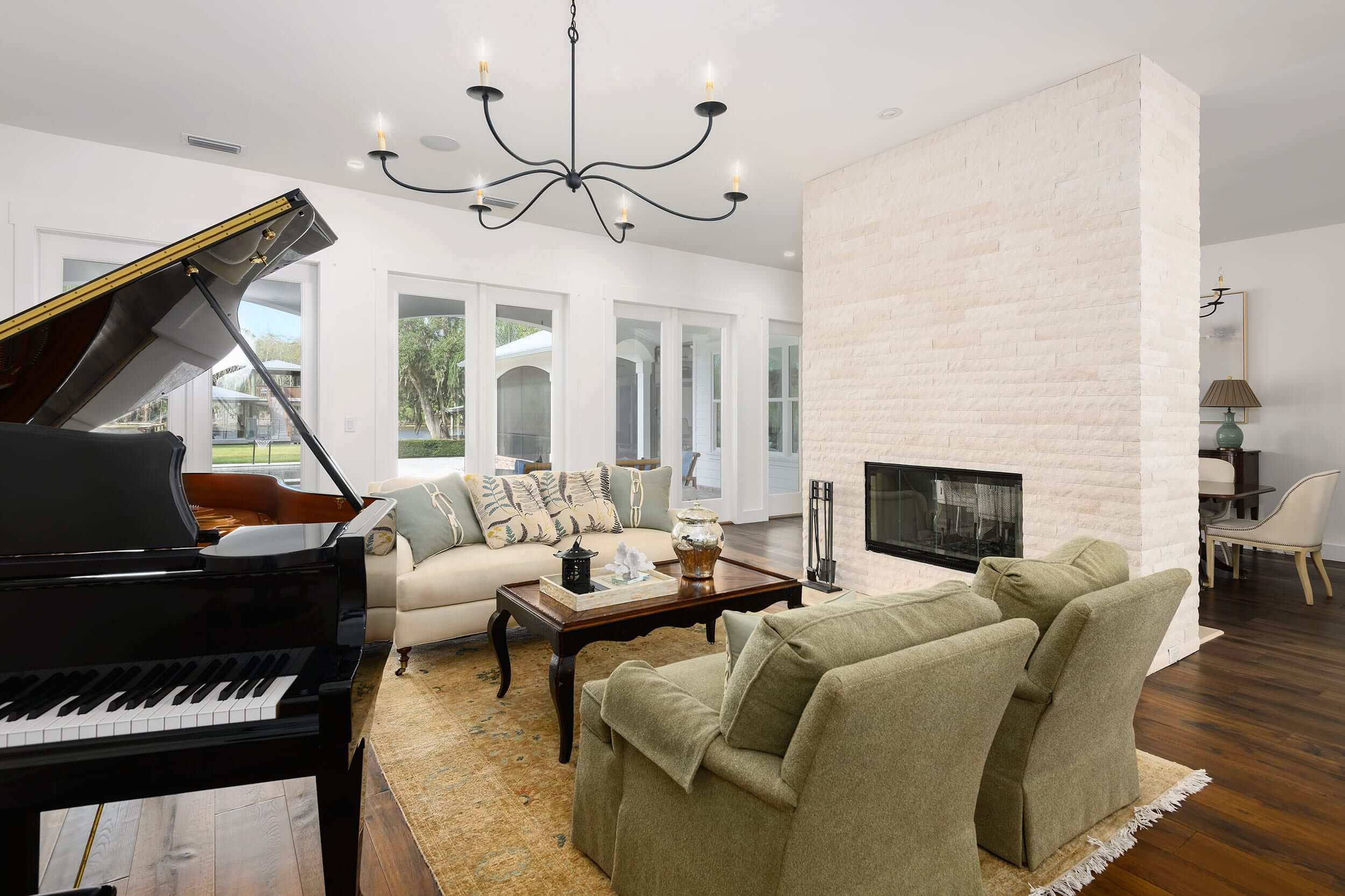 Bright living room with elegant furniture and a grand piano.