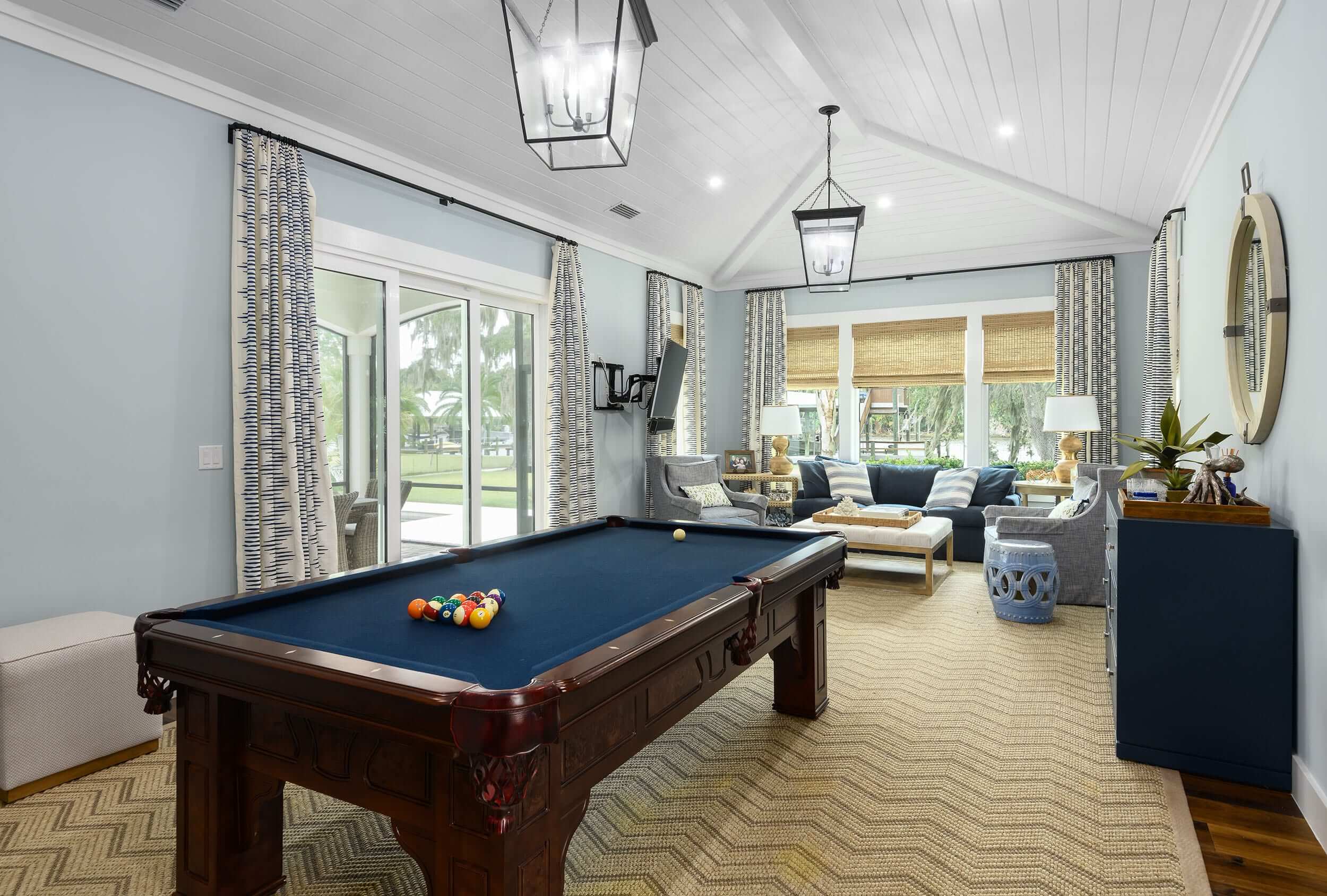 Elegant game room with pool table and cozy seating area.